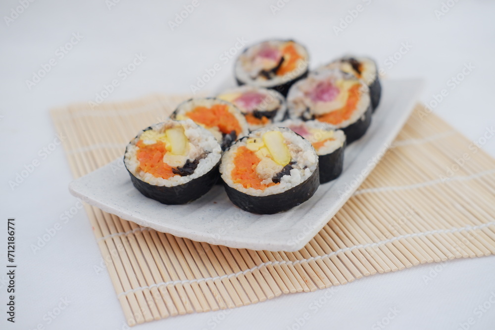 Sushi rolls on a plate on a white background. Japanese food Sushi rolls on a plate on a white background. Japanese food