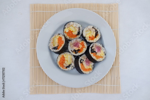 Sushi rolls on a plate on a white background. Japanese food