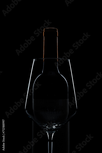 silhouette of wine glass and bottle in black background