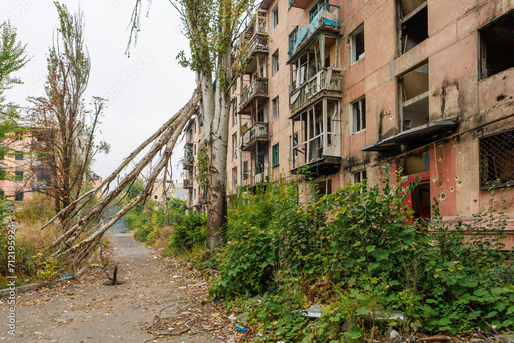 Closeup view of ruined facade of house in Mariupol.