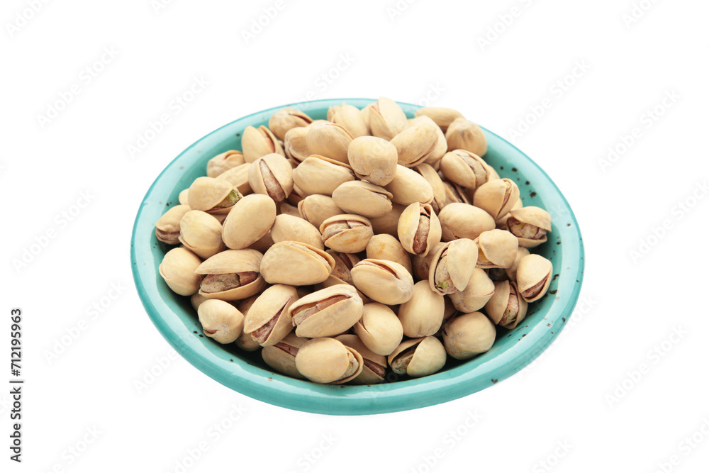 Salted pistachios for beer isolated on white background. Healthy delicious pistachios in plate. Salted pistachios for beer isolated on white background. Healthy delicious pistachios in plate.