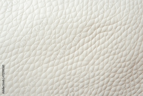 A close-up of a white leather surface. Monochrome texture background