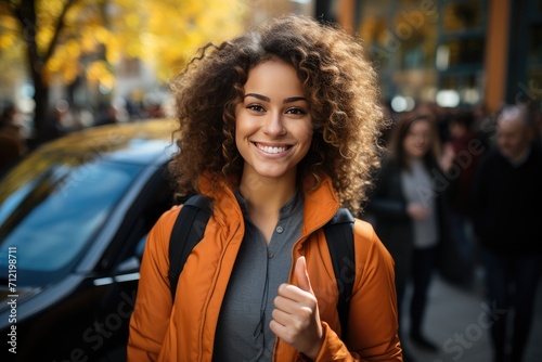 Attractive young woman standing beside new car, expressing pride and satisfaction in her achievement of obtaining a driver license and new car, symbolizing freedom and independence