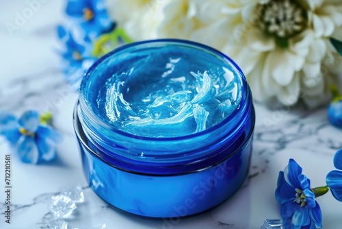 Blue jar of petroleum jelly for moisturizing and skincare photo