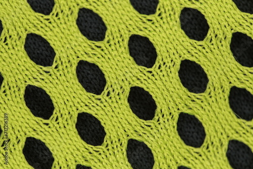 A fragment of fabric with holes in a close-up