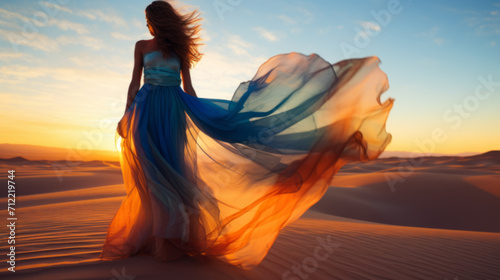 young woman in silk dress on desert dunes