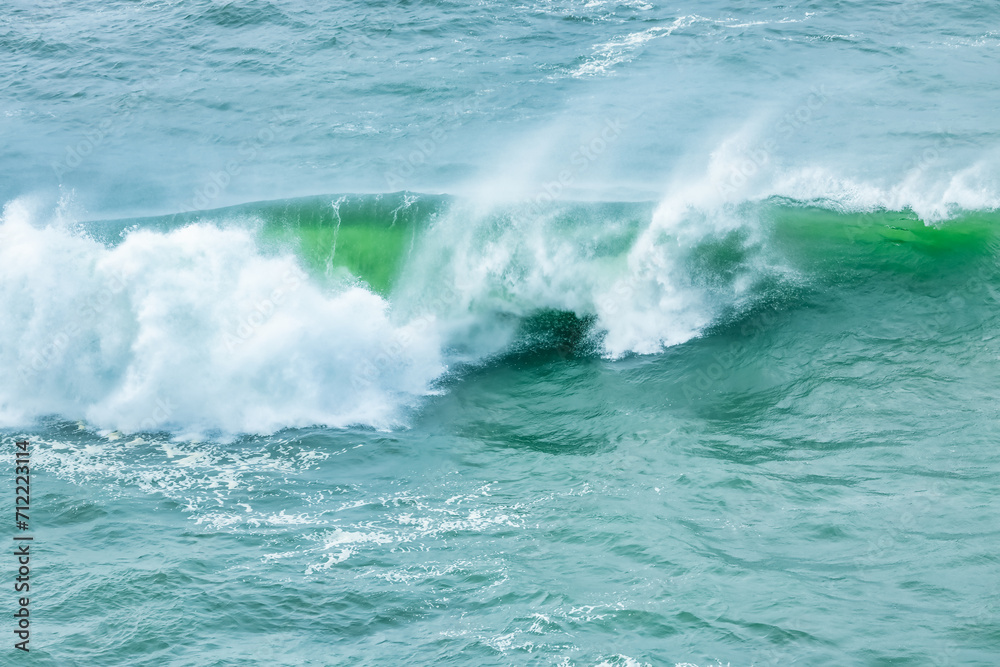 Fototapeta premium Wave splashing close-up. Crystal clear sea water, in the ocean in San Francisco Bay, blue water, pastel colors.