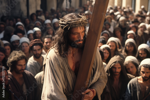 Jesus Christ via the cross, walking through the streets among a crowd of people with the cross on his back photo