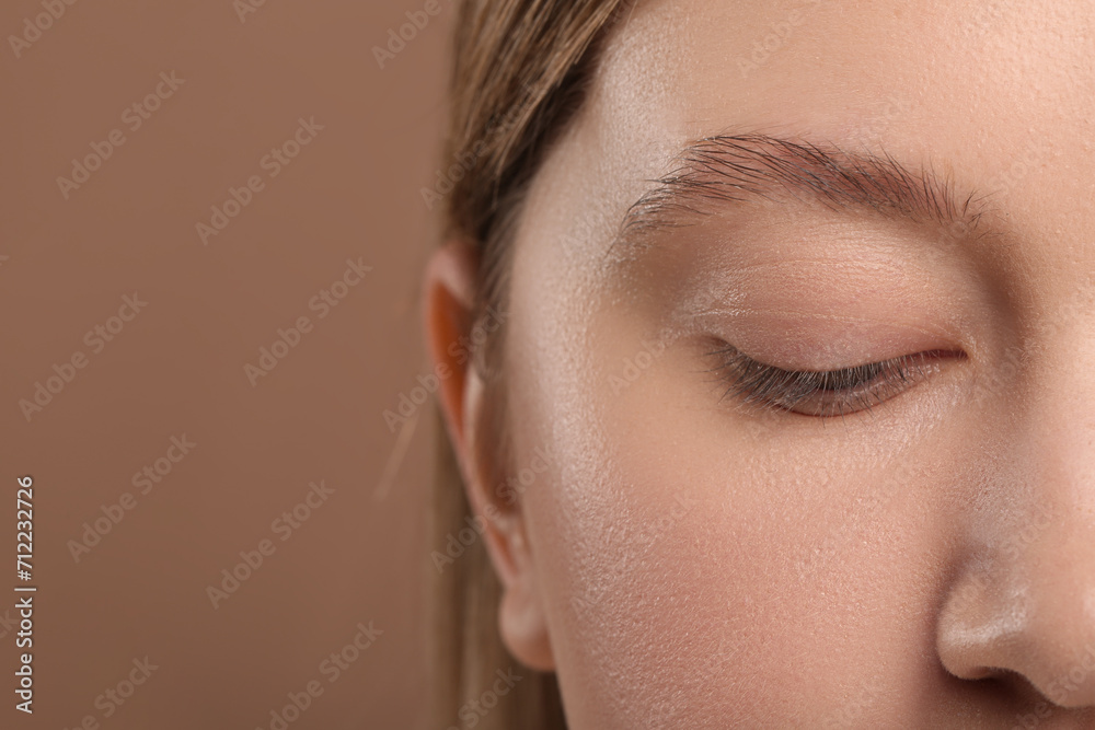 Woman with beautiful natural eyelashes on light brown background, closeup. Space for text Woman with beautiful natural eyelashes on light brown background, closeup. Space for text