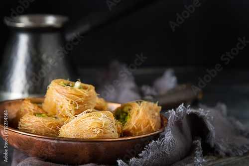 Traditional arabic dessert baklava with pistachios. Dark background