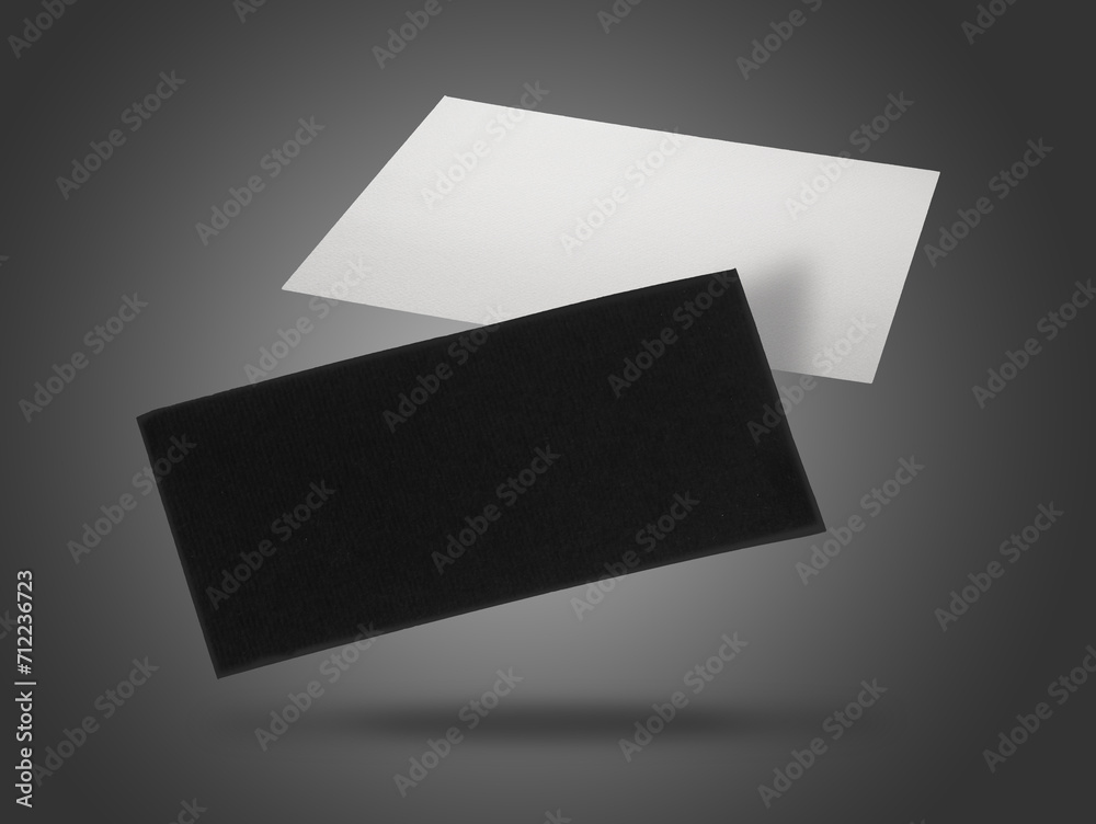 Blank business cards in air on grey background. Mockup for design