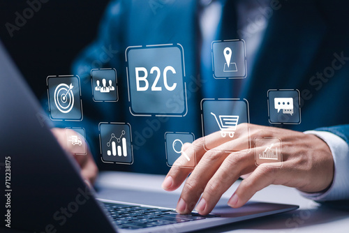 B2C Business to customer marketing strategy concept. Businessmen use laptop with virtual B2C icons. E-commerce marketing strategy. photo