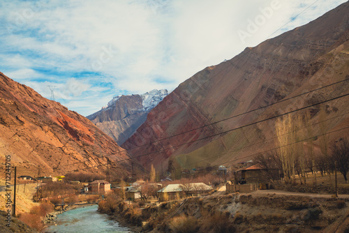 the river flow in a town city with a bridge connecting each other town in Tajikistan photo