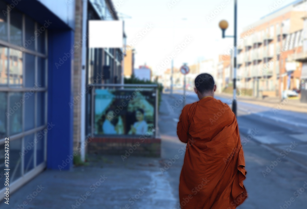 The monk is walking on the street