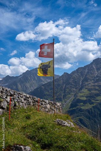 Canvastavla Swiss flag an flag of canton uri waving in the wind at a mountain hut in Switzer
