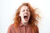 Portrait of young angry woman screaming on white background