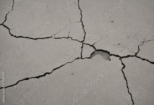 Vintage gray cracked concrete texture close-up with grunge effect.