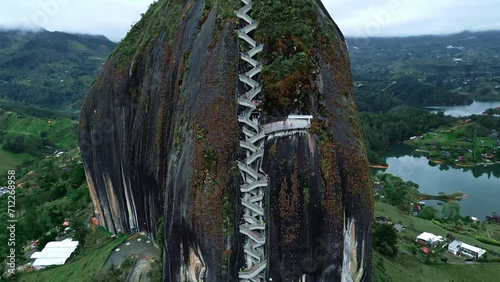 Close Aerial drone shot of long stairs to the top of El Penon de Guatape near Medellin, Colombia. Big Stone