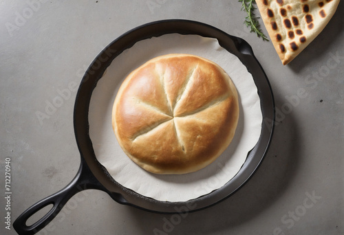 Skillet-cooked pita bread on concrete surface photo