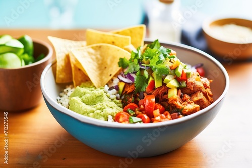 quinoa burrito bowl with guacamole and tortilla chips
