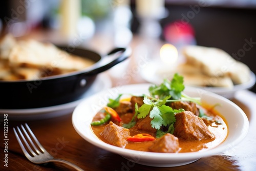 close up of rogan josh served with naan bread