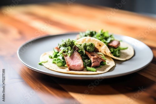 lamb tacos with mint cilantro chutney on a ceramic plate