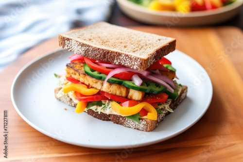 marinated tempeh sandwich with bell peppers and onions