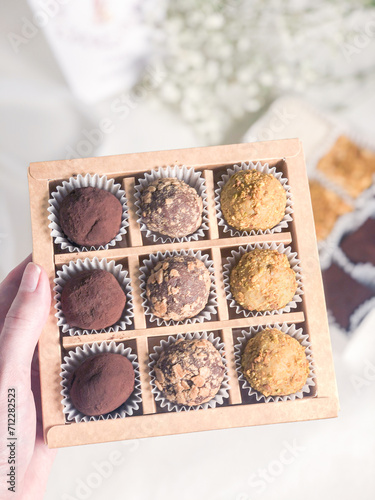 A set of chocolate truffles with nuts and cocoa.