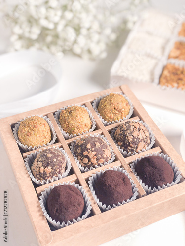 A set of chocolate truffles with nuts and cocoa.