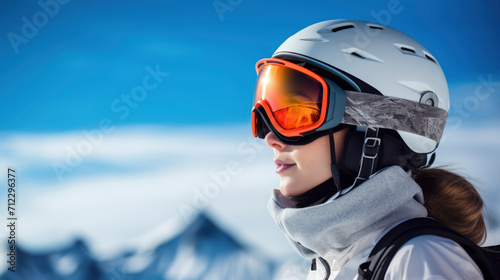 Side profile, Portrait of female, Skier wearing fashionable, goggles and helmet with blue sky and snowy peaks in the background
