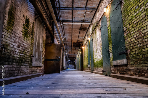 Corridor in an old  abandoned jail with brick walls