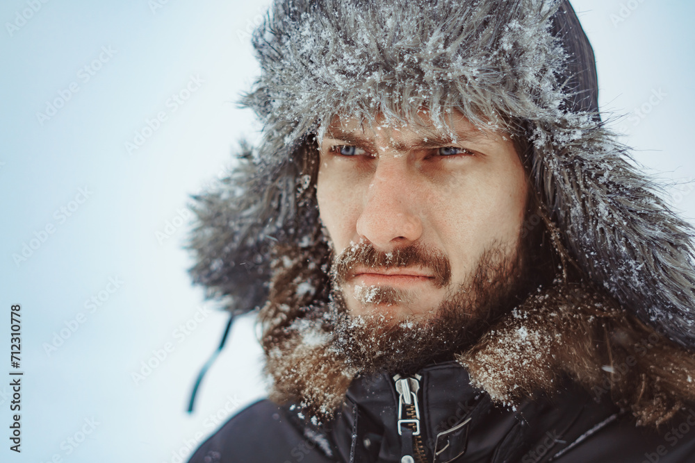 a bearded man in an earflap in winter a bearded man in an earflap in winter