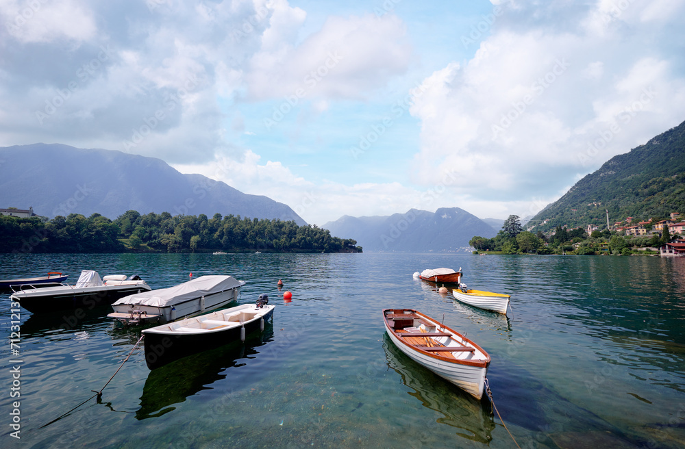 Beautiful scene of boats on lake Como in Italy. A big blue lake surrounded by green hills