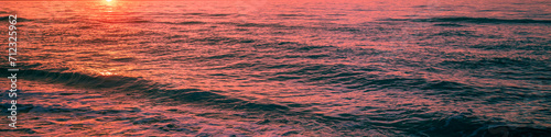 Seascape in the early morning. Sunrise over the sea. Water surface. Horizontal banner
