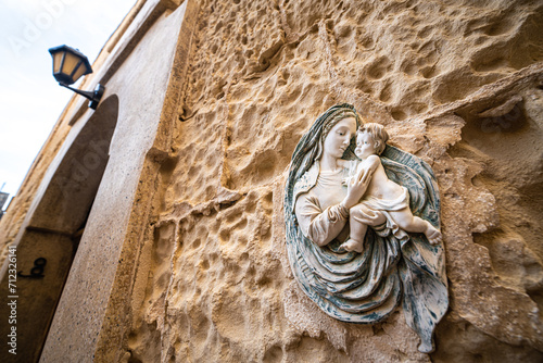 Religious Virgin Mary figure on a house wall