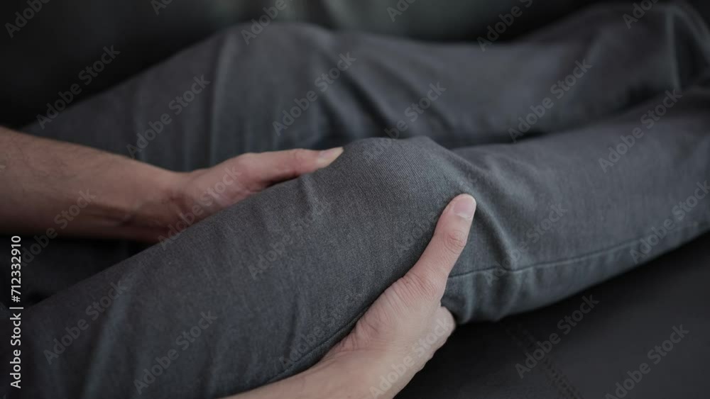 Hands massaging knees to relieve pain Hands massaging knees to relieve pain