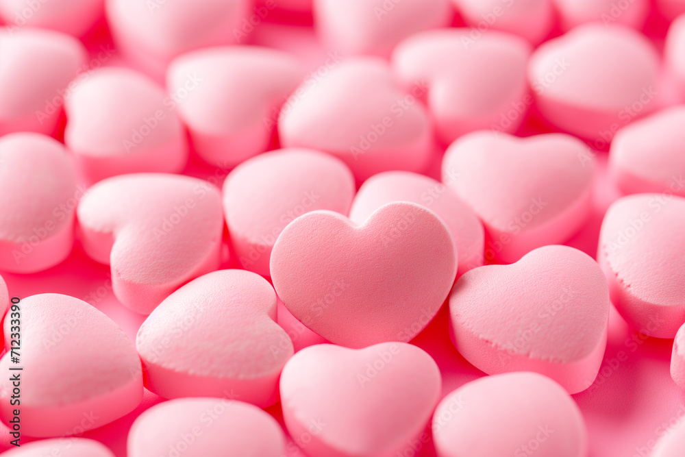 Closeup of pink candy hearts and sweets in shape of love symbol on pink background, for Valentine's day Closeup of pink candy hearts and sweets in shape of love symbol on pink background, for Valentine's day
