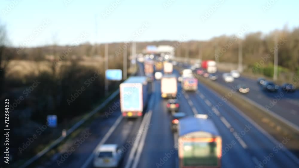 Blurry, defocussed high angle view of heavy highway traffic flow in England in autumn, backgrounds.