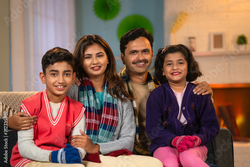 Indian happy family portraitshot in winter wear - concept of family bonding, holiday gathering and leisure lifestyles