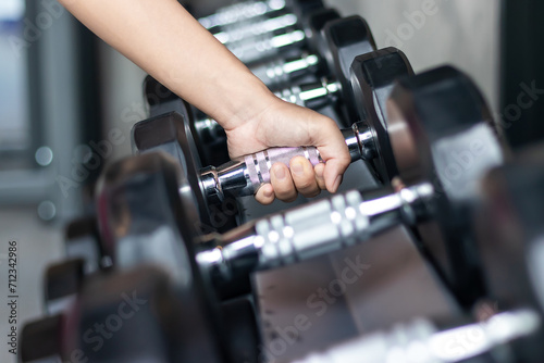 Rows of stainless dumbbell in the gym, Sports dumbbells in modern sports club.