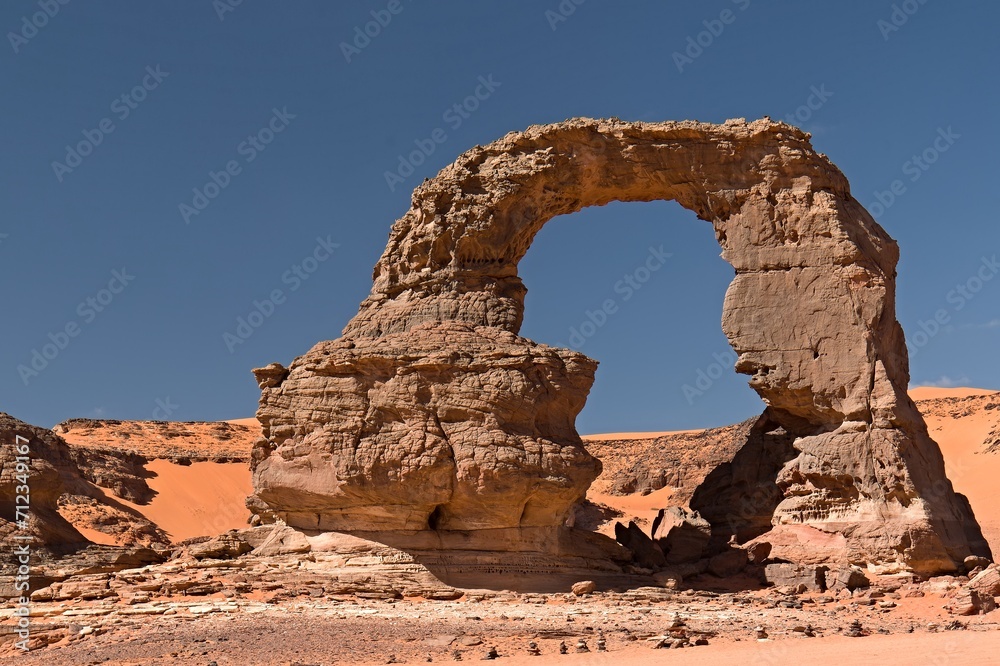 View on the Tehak Arch, a rock arch in Tadrart Rouge, Tassili N Ajjer National Park. Sahara, Algeria, Africa.