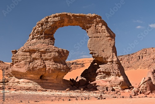View on the Tehak Arch, a rock arch in Tadrart Rouge, Tassili N Ajjer National Park. Sahara, Algeria, Africa.