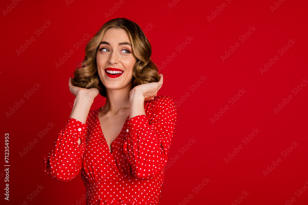 Photo of pretty elegant lady hands touch wavy hair look empty space isolated on vivid red color background