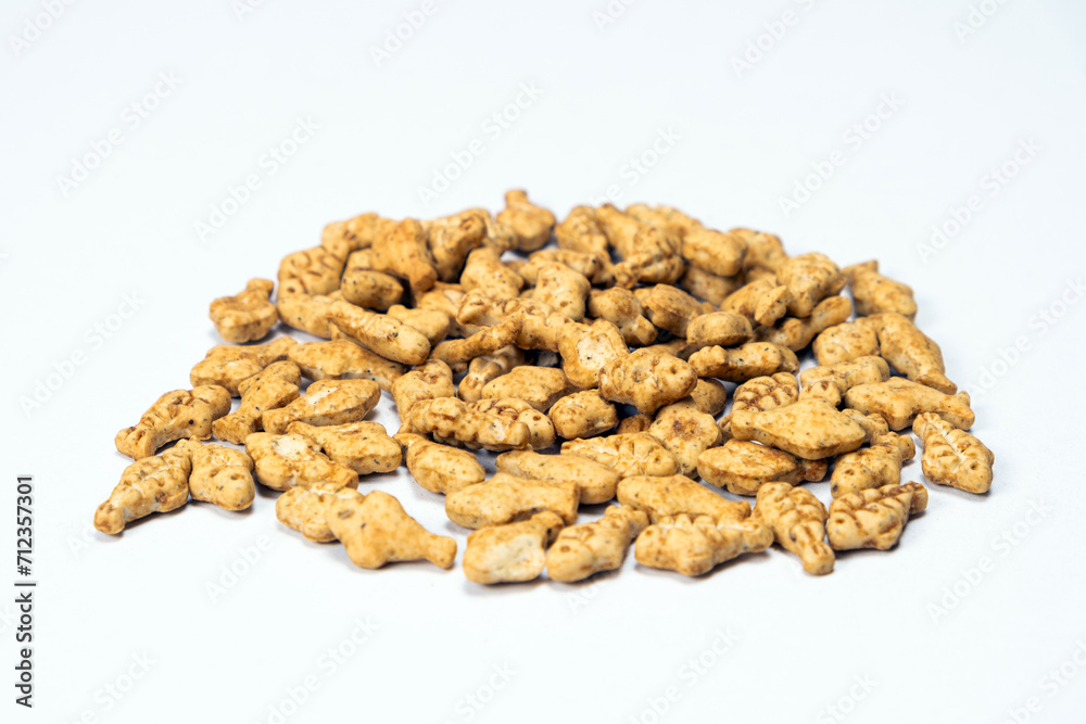 A treat for cats and kittens is a fish-shaped catnip cookie close-up.