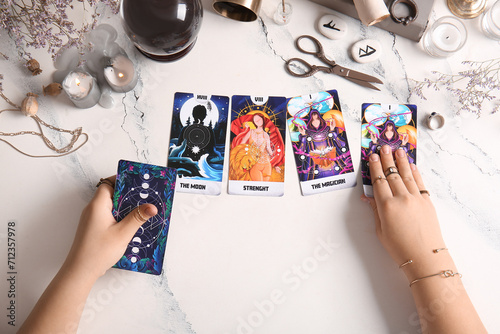 Witch with tarot cards on l...