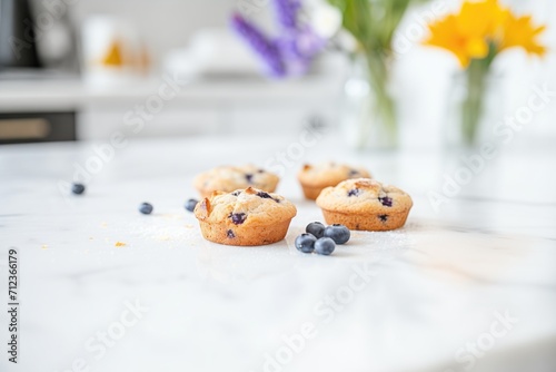 blueberry muffins on a white marble counter