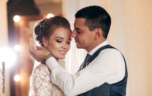 bride and groom hugging in a bright room