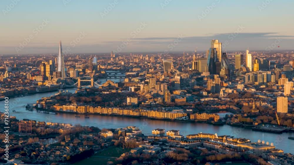 Beautiful sunrise timelapse view of the urban skyline of London, England, with soft orange sunlight reflecting at the skyscrapers Beautiful sunrise timelapse view of the urban skyline of London, England, with soft orange sunlight reflecting at the skyscrapers