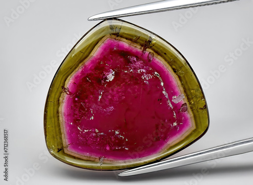 Fotografie natural watermelon tourmaline gem on the background