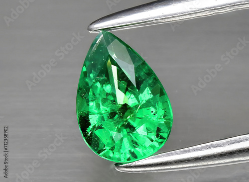 natural green tsavorite garnet gem on the background photo